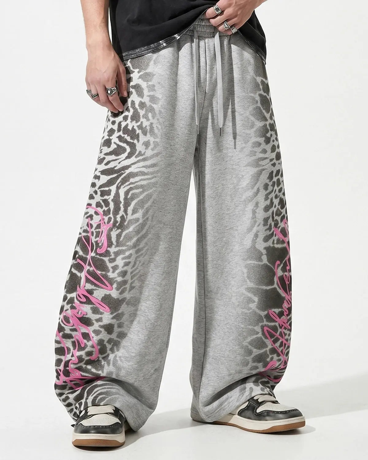 Leopard graphic barrel sweatpants by INFLATION featuring bold animal print and relaxed fit streetwear style.