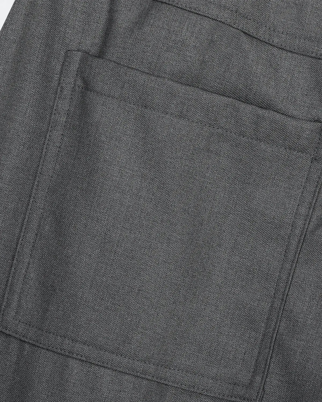 Asymmetric pleated barrel-leg pants by INFLATION, stylish streetwear suit pants with unique pleats and relaxed fit.