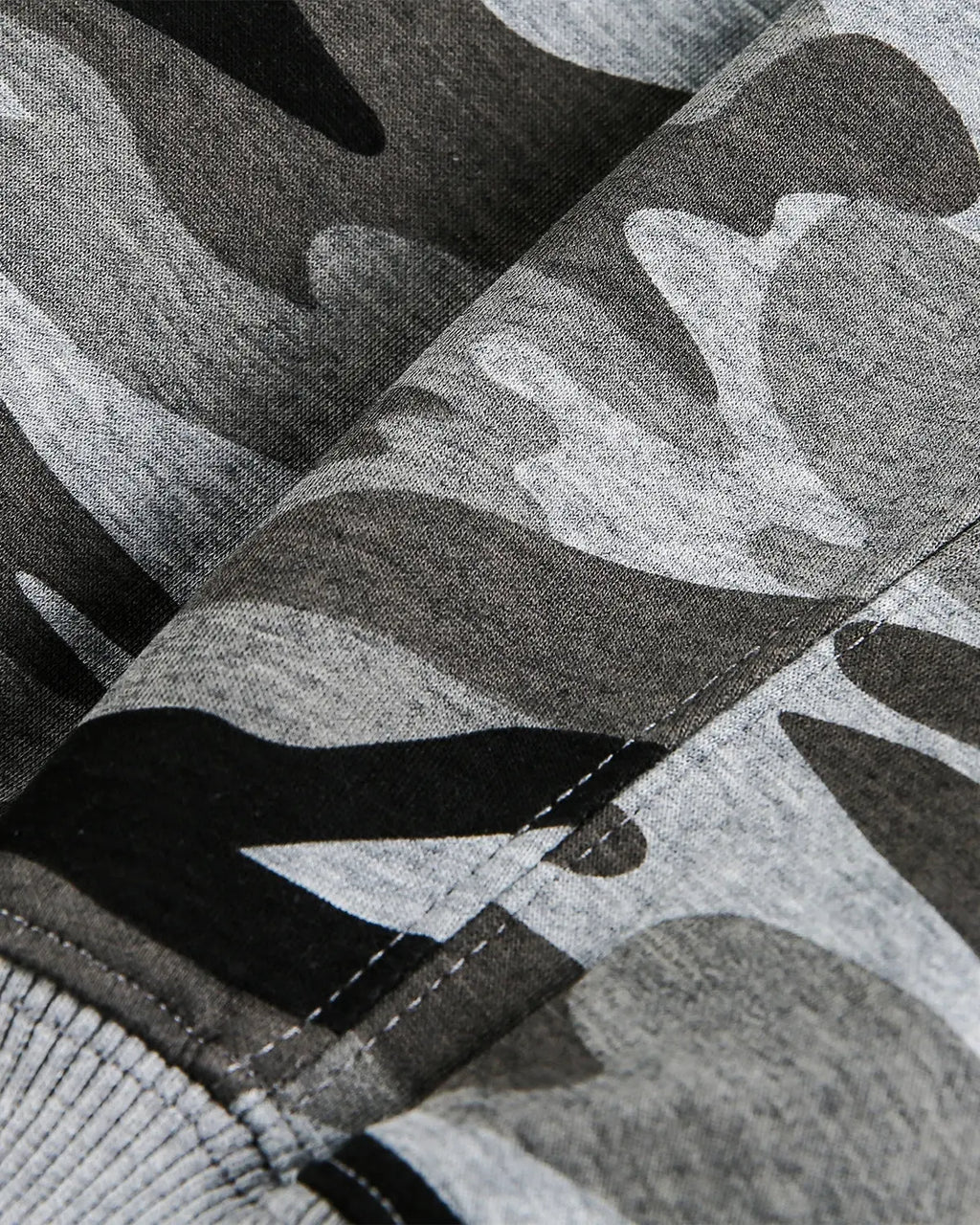Cropped camouflage zip-up hoodie by INFLATION featuring a green and black camouflage pattern and a front zipper.