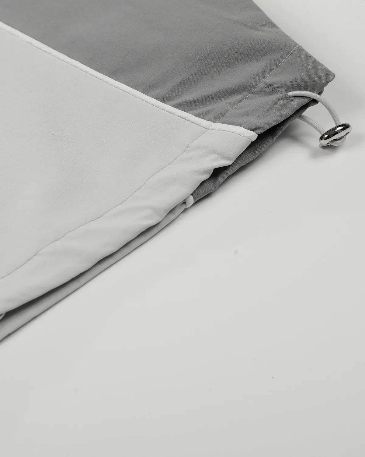 Inflation Contrast Panel Baggy Track Pants featuring black and white color blocks and a loose, comfortable fit for streetwear style.