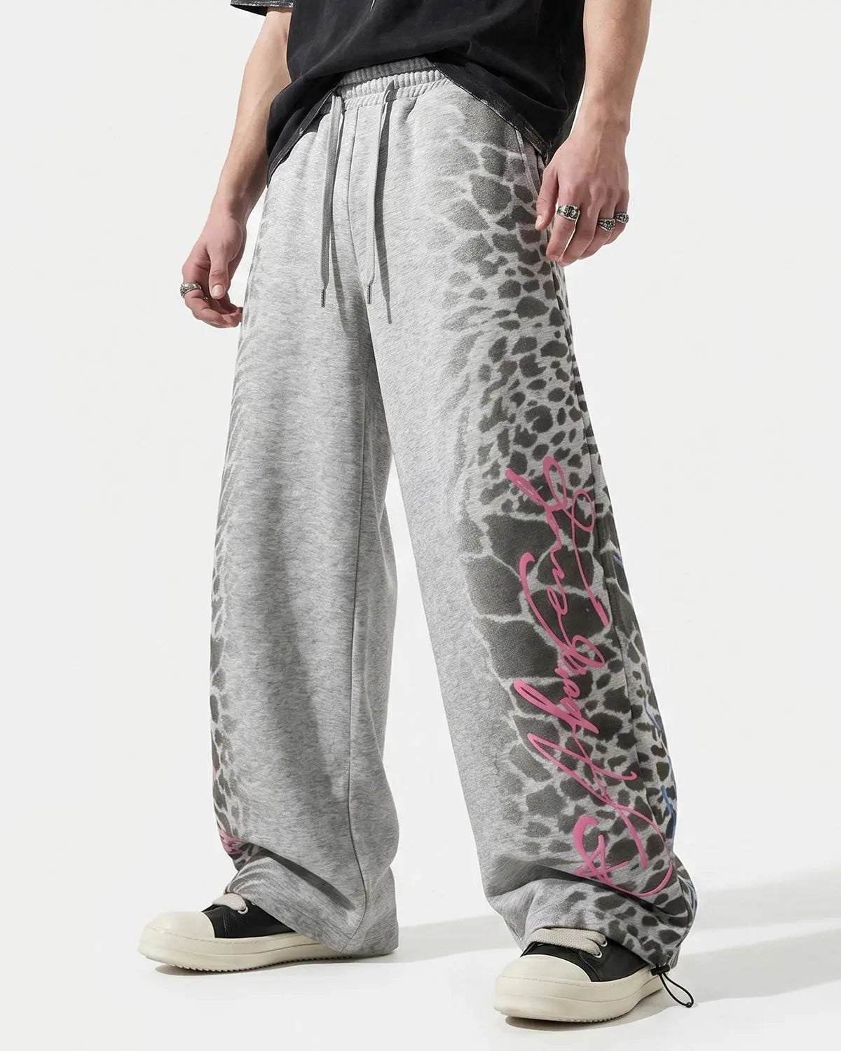 Leopard graphic barrel sweatpants by INFLATION featuring bold animal print and comfortable streetwear style.