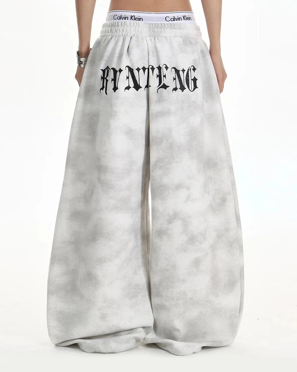 Washed black cross barrel sweatpants by INFLATION, featuring a relaxed fit and stylish streetwear design with brand logo detail.