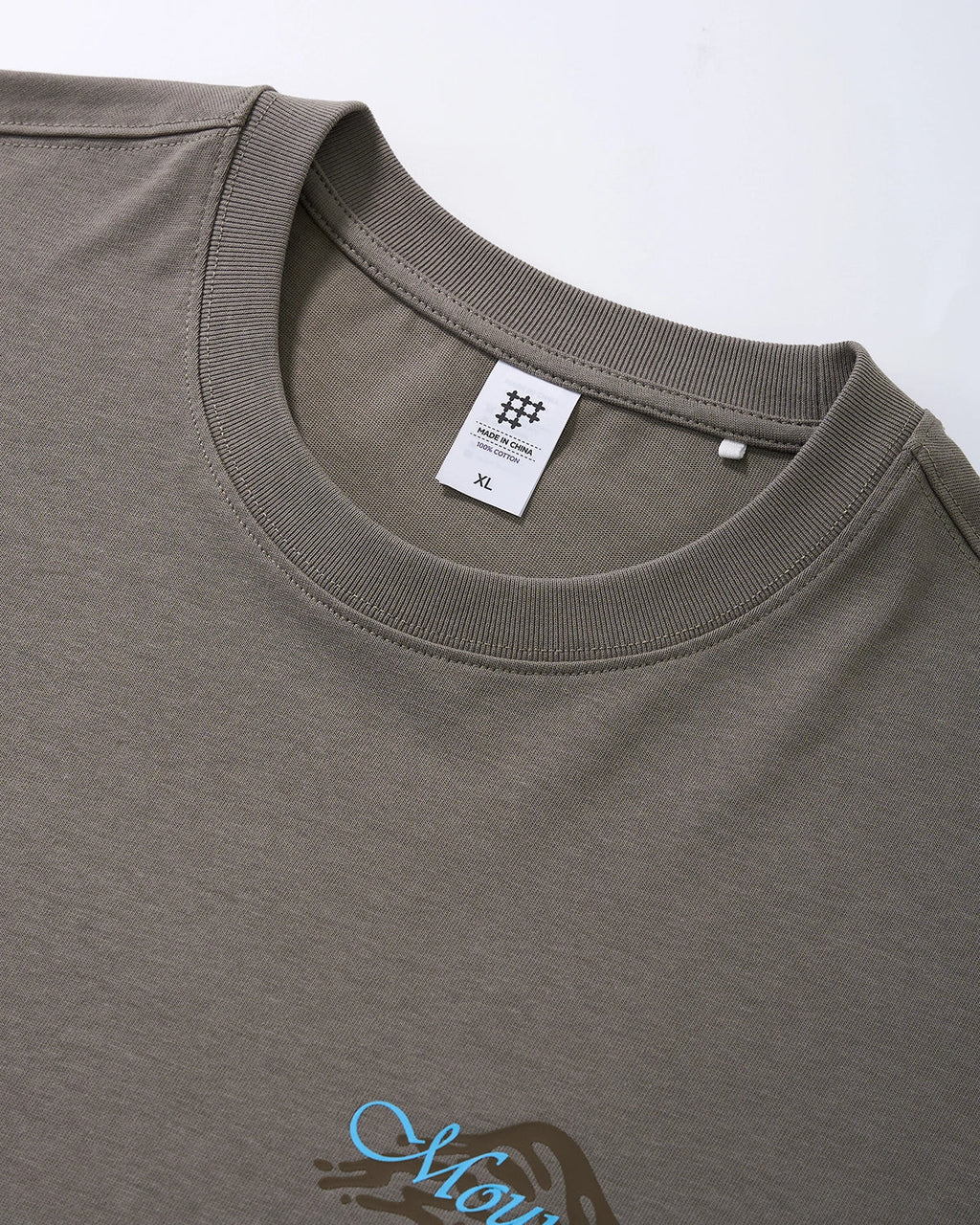 Inflation brand heavyweight oversized graphic T-shirt with bold print, casual streetwear style, shown on a model against a neutral background.