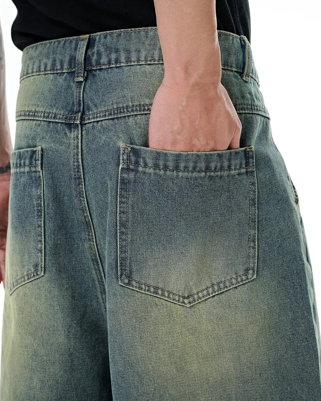 Pair of Flation Retro Washed Denim Jorts with frayed hems, casual streetwear style, shown on a model.