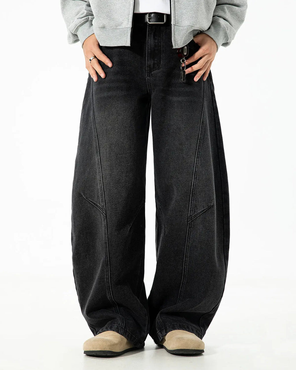 Curved seam deconstructed barrel jeans by INFLATION, featuring unique stitching and relaxed fit, shown in a stylish streetwear look.