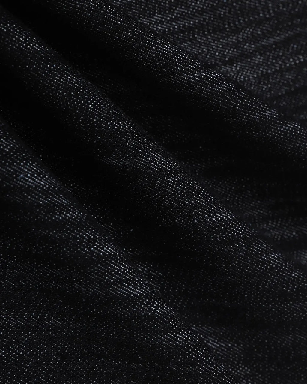 Embroidery detail on raw baggy jeans from INFLATION Streetwear, showcasing loose fit and distressed denim style.