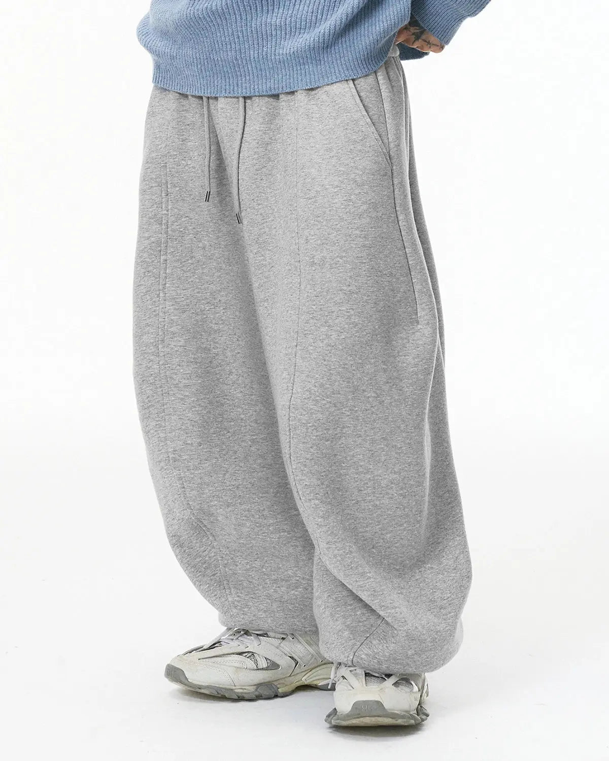 Grey baggy jogger sweatpant from Inflation Streetwear, relaxed fit with elastic waistband and cuffed ankles, casual streetwear style.