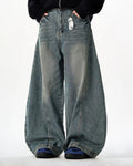 Vintage washed barrel jeans by INFLATION, showing relaxed fit denim with distressed detailing and classic five-pocket style.