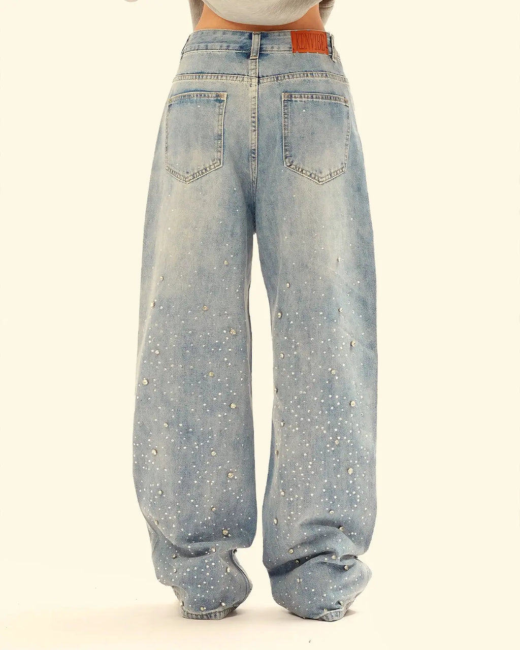 Flation studded rhinestone baggy jeans with distressed details, casual streetwear style, and embellished design visible in the image.