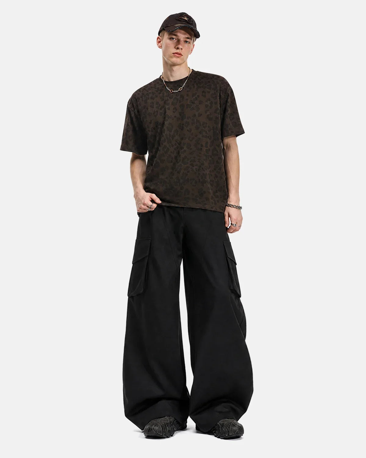 Inflation structured wide-leg cargo pants with multiple pockets and relaxed fit, styled on a model for streetwear fashion.