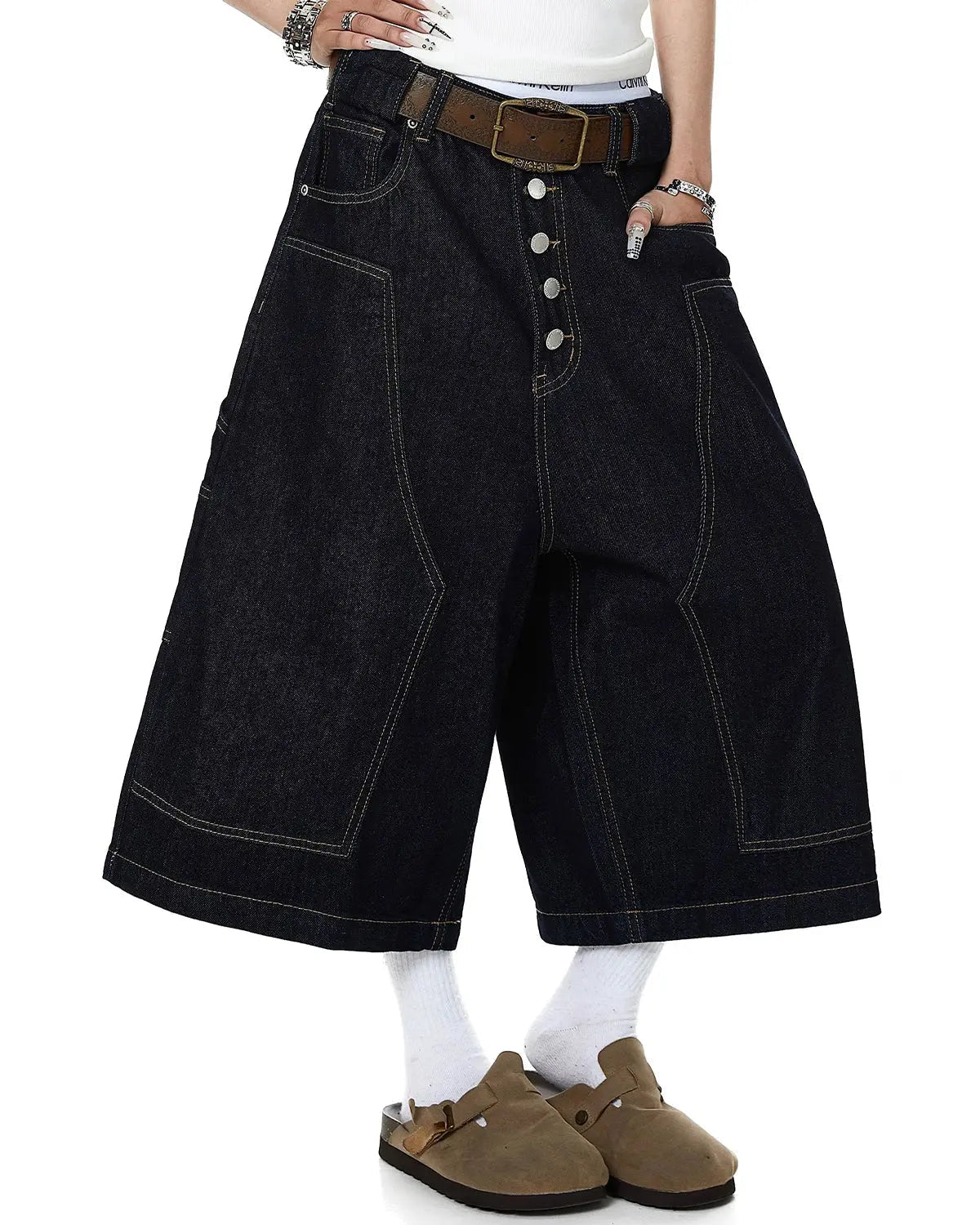 Deconstructed wide-leg longline jorts by INFLATION featuring distressed denim, high waist, and relaxed fit, styled with casual streetwear.