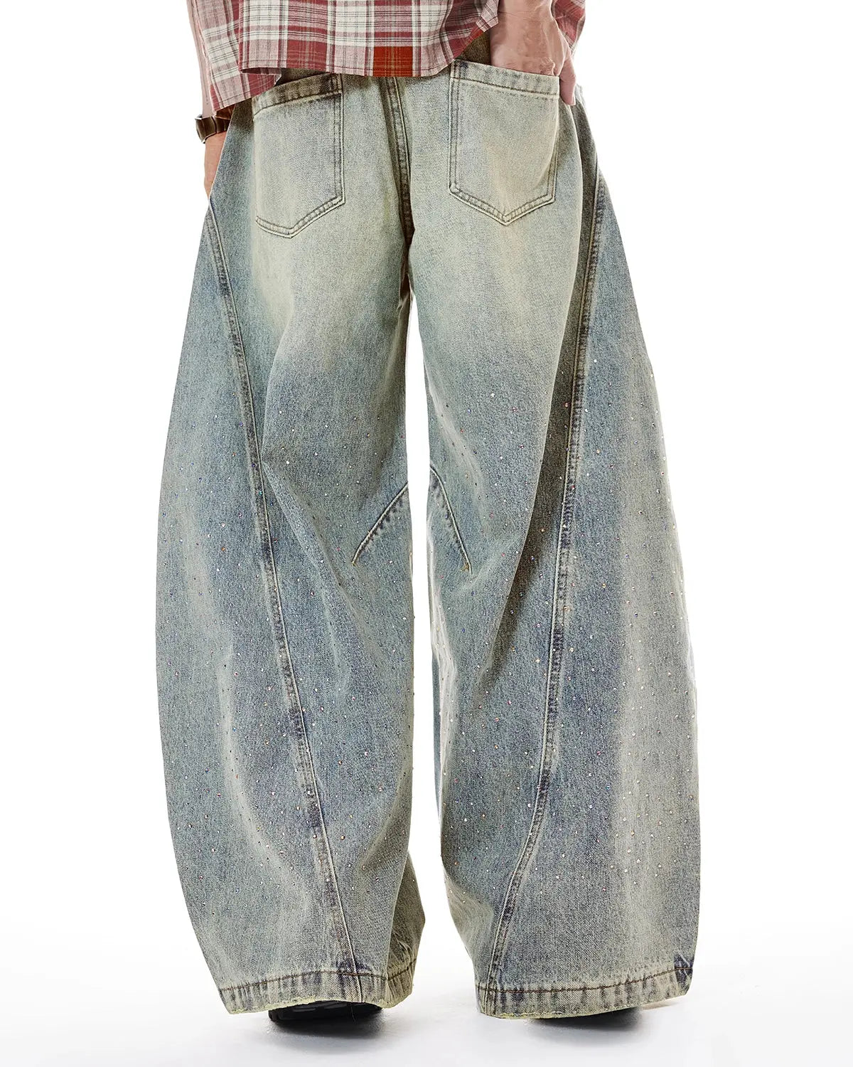 Colorful rhinestones on ripped baggy jeans by INFLATION, streetwear pants with bold, vibrant embellishments and distressed style.