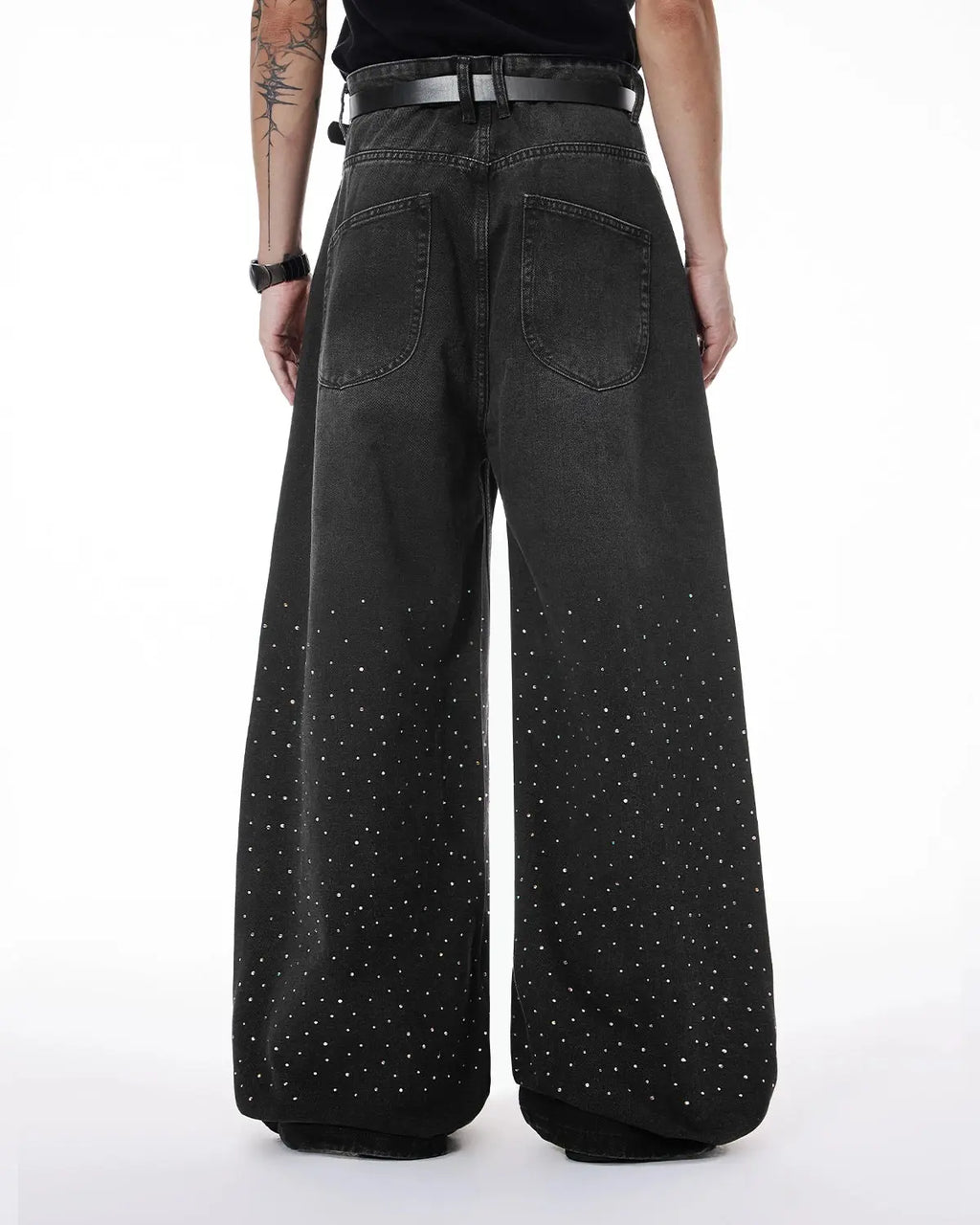 Acid washed rhinestone baggy jeans by Flation, streetwear pants with rhinestone embellishments and relaxed fit, shown on a model.