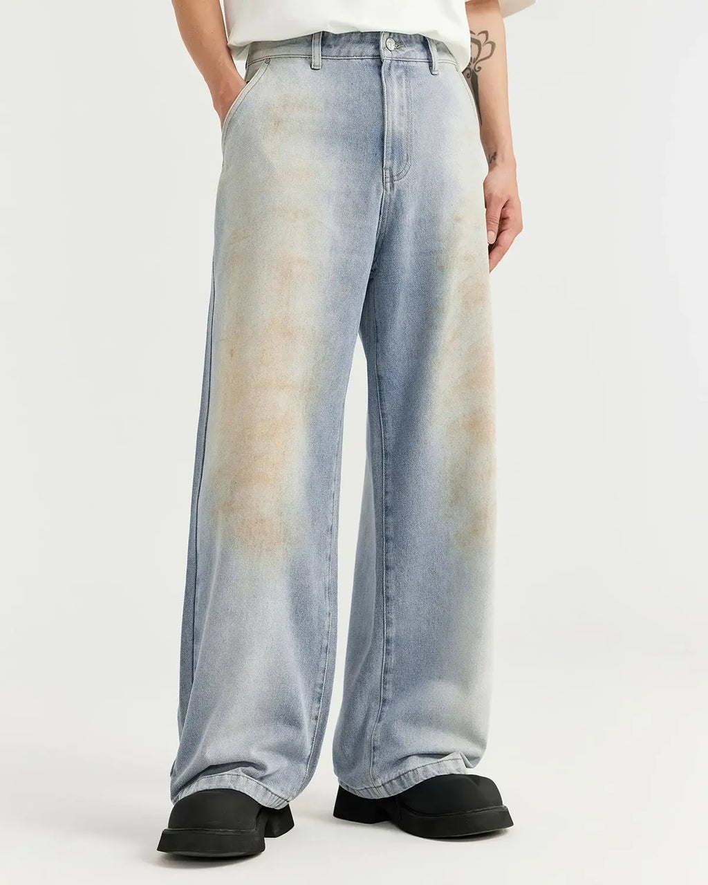 Mud Washed Baggy Jeans by Flation, featuring a relaxed fit and distressed denim look, displayed on a neutral background.