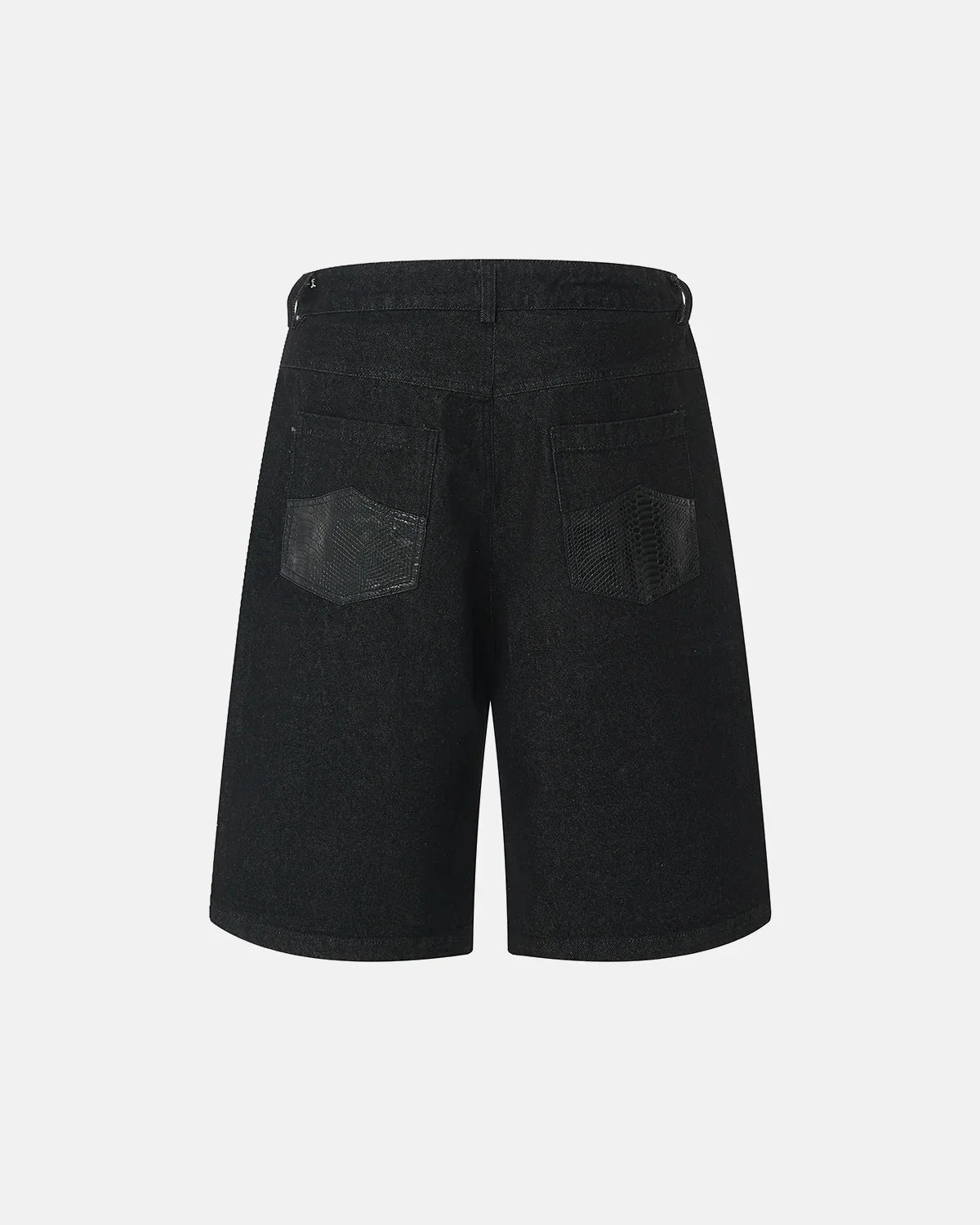 Black baggy long jorts by INFLATION, oversized denim shorts with a relaxed fit, visible distressed details and raw hem.