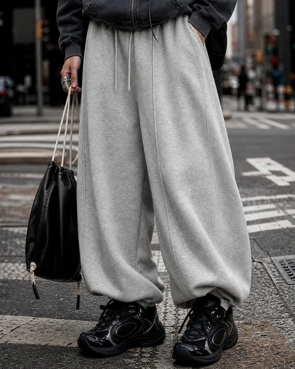 Grey baggy jogger sweatpants by INFLATION Streetwear with a relaxed fit and elastic waistband, shown on a plain background.