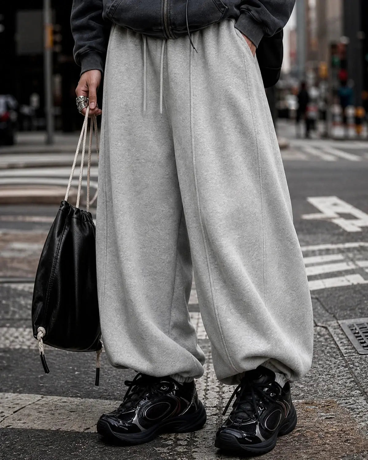 Grey baggy jogger sweatpants by INFLATION Streetwear with a relaxed fit and elastic waistband, shown on a plain background.