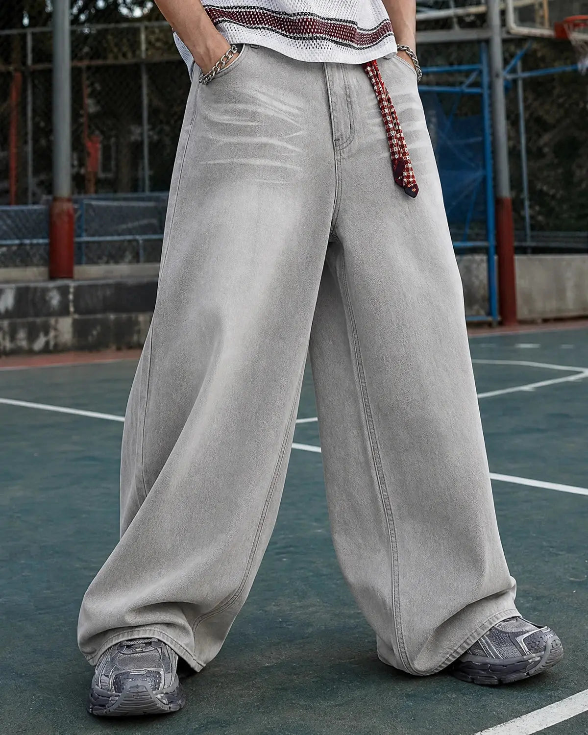 Washed distressed baggy jeans by Flation Streetwear, featuring a relaxed fit with ripped details and faded denim appearance.