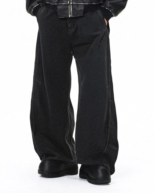 Acid washed black barrel jeans by Flation featuring a relaxed fit, distressed details, and classic five-pocket design.