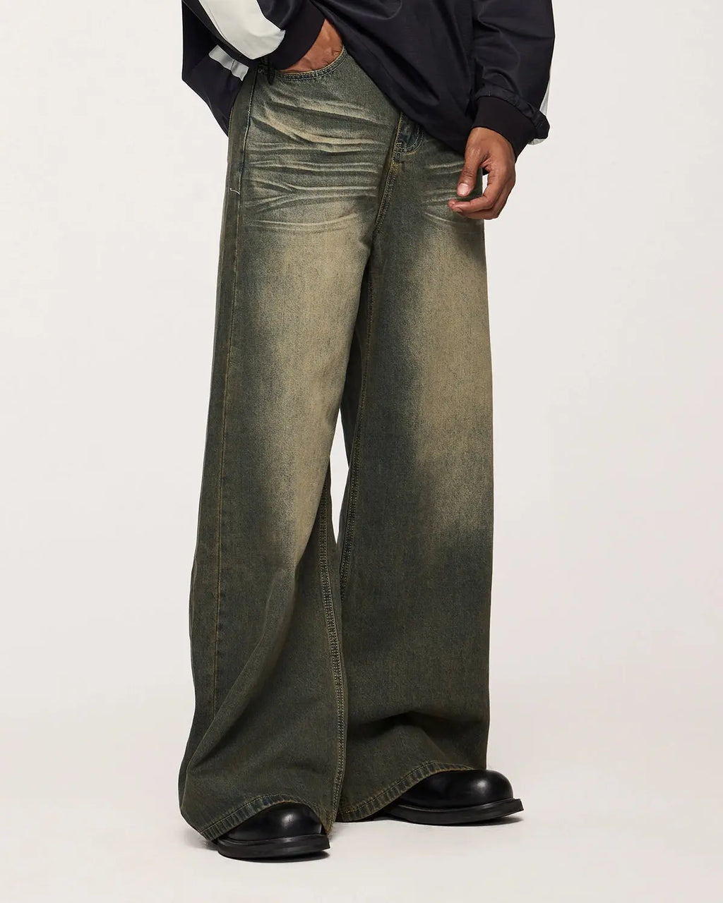 Flation streetwear washed loose-fit denim pants with relaxed fit and distressed details on a model.