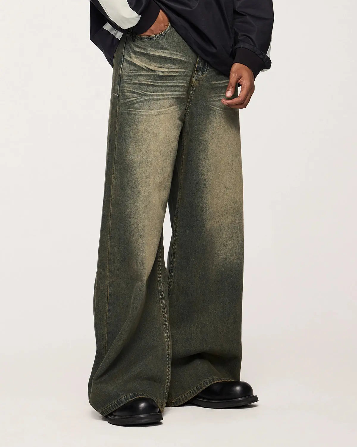 Flation streetwear washed loose-fit denim pants with relaxed fit and distressed details on a model.