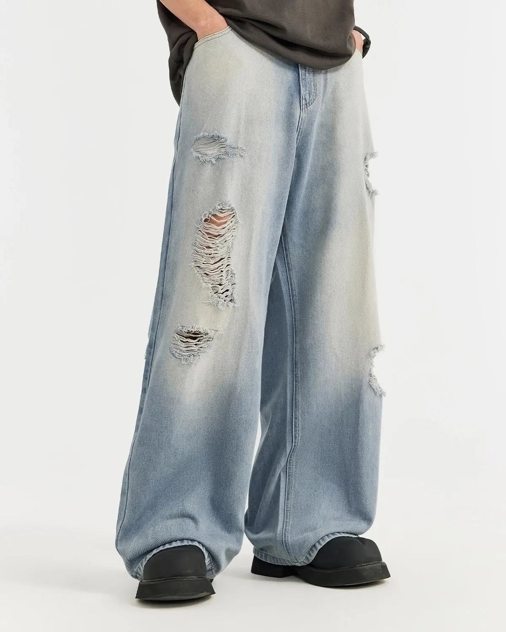 Distressed ripped blue jeans by INFLATION Streetwear featuring ripped details and a casual, trendy fit.