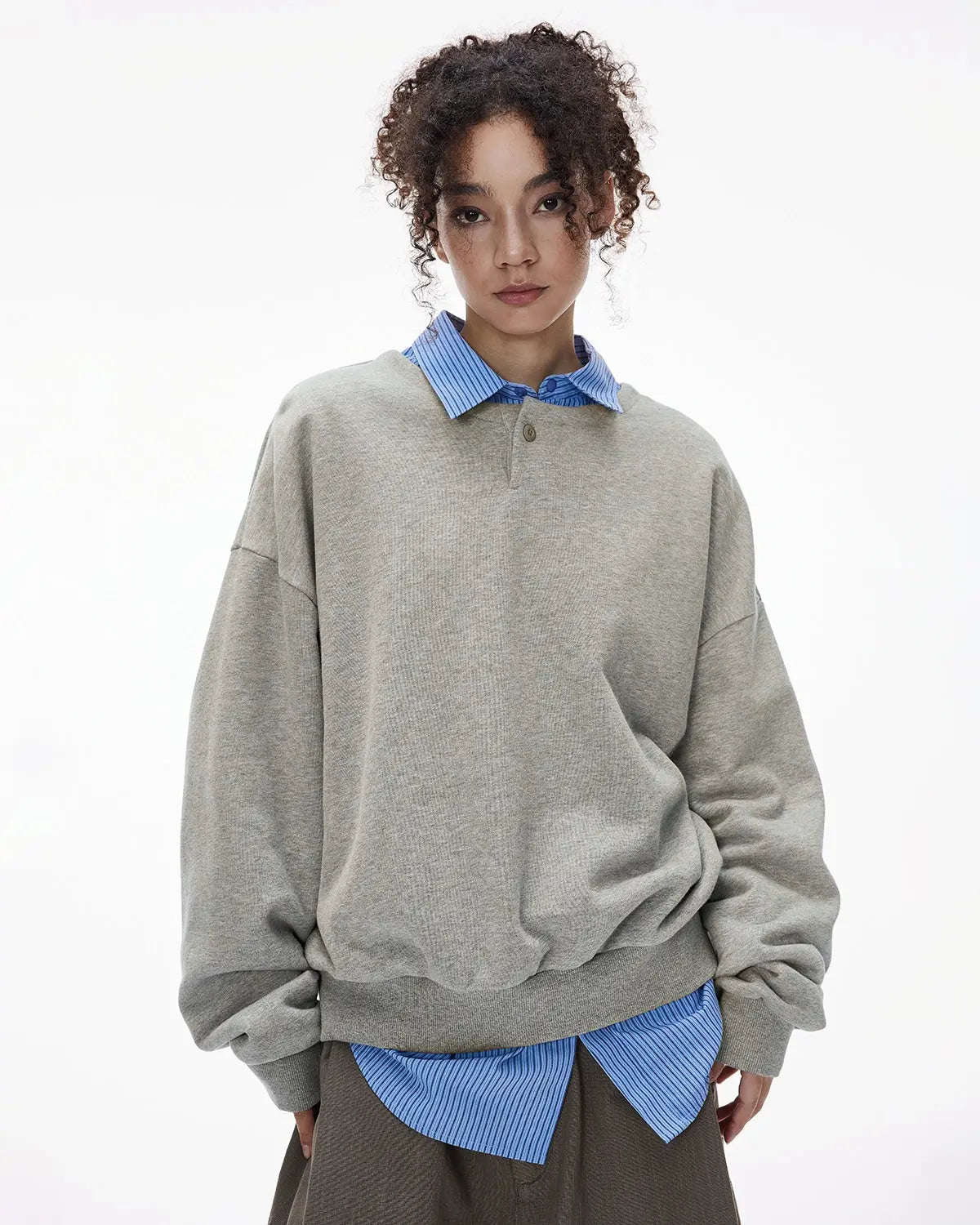 Boxy fit Henley collar sweatshirt by Flation featuring a relaxed style and detailed button placket, displayed on a model.