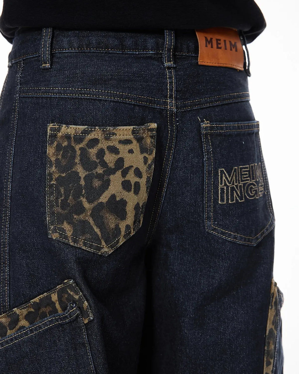 Leopard patch rhinestone barrel jeans by INFLATION featuring streetwear style with bold animal print and sparkling rhinestone details.