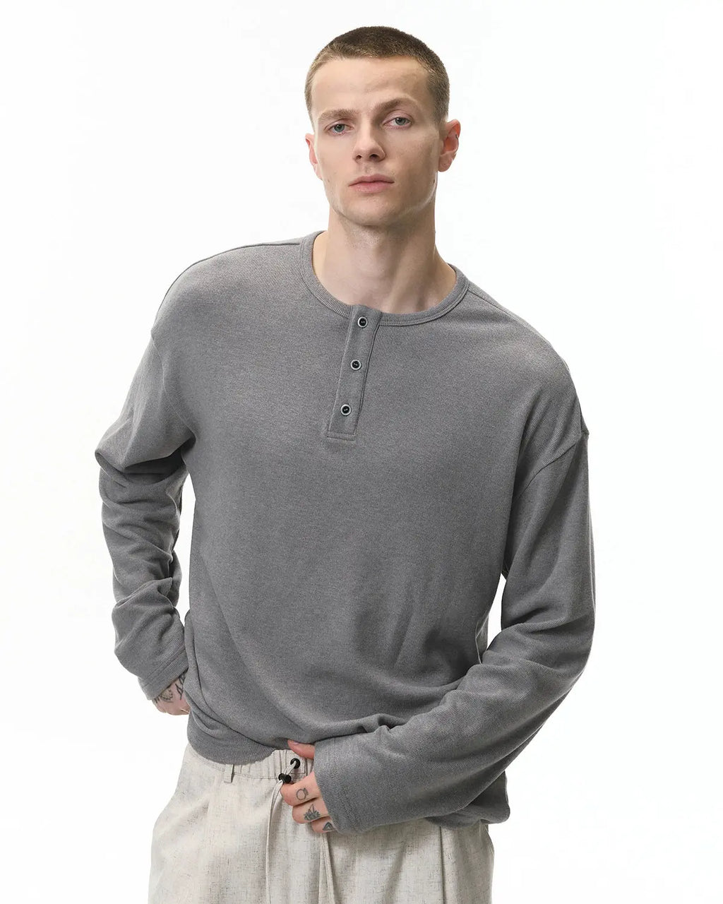 Inflation Streetwear Henley collar long sleeve t-shirt in black, featuring a casual fit and buttoned neckline.