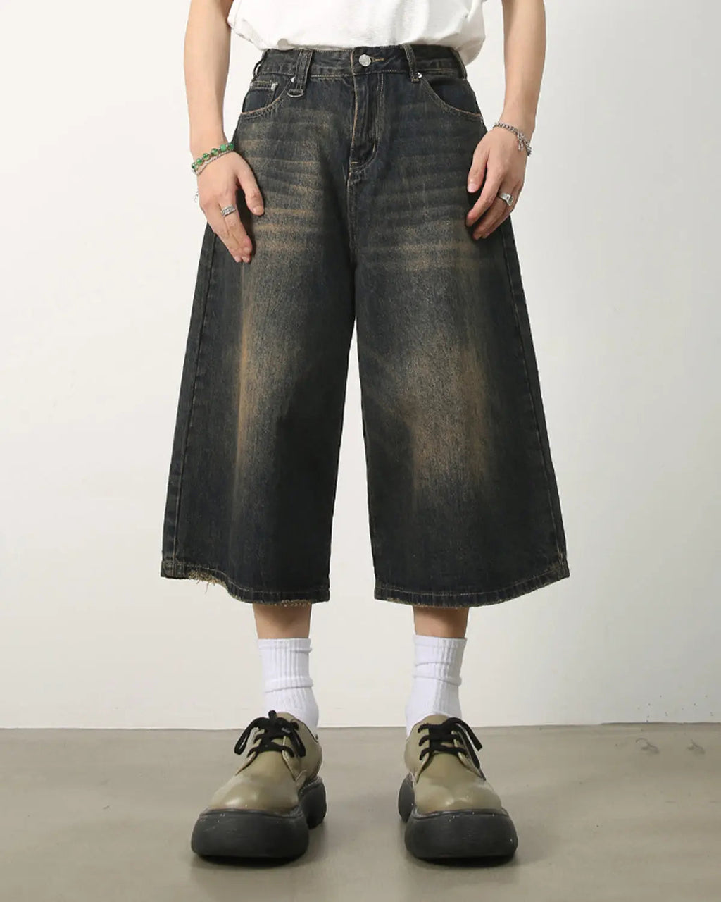 Washed baggy denim jorts by INFLATION featuring a relaxed fit and distressed details, styled as streetwear casual shorts.