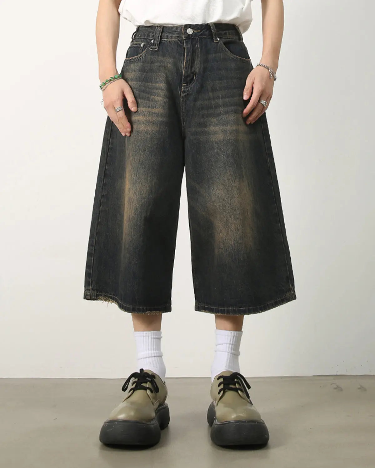 Washed baggy denim jorts by INFLATION featuring a relaxed fit and distressed details, styled as streetwear casual shorts.
