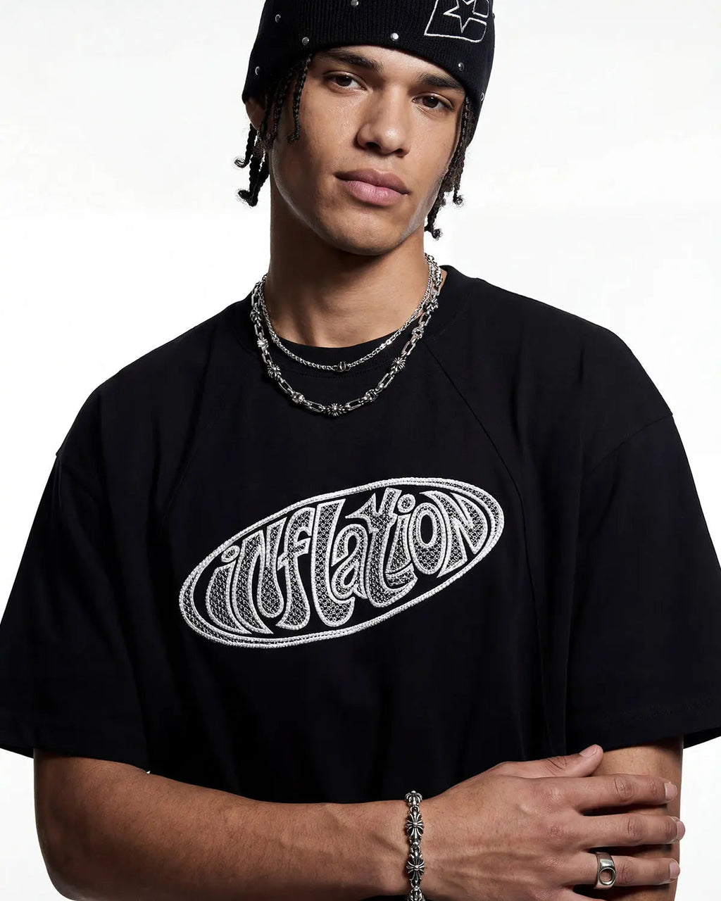 Hollow embroidered graphic T-shirt by INFLATION featuring unique design and streetwear style, shown with a close-up of the embroidery.