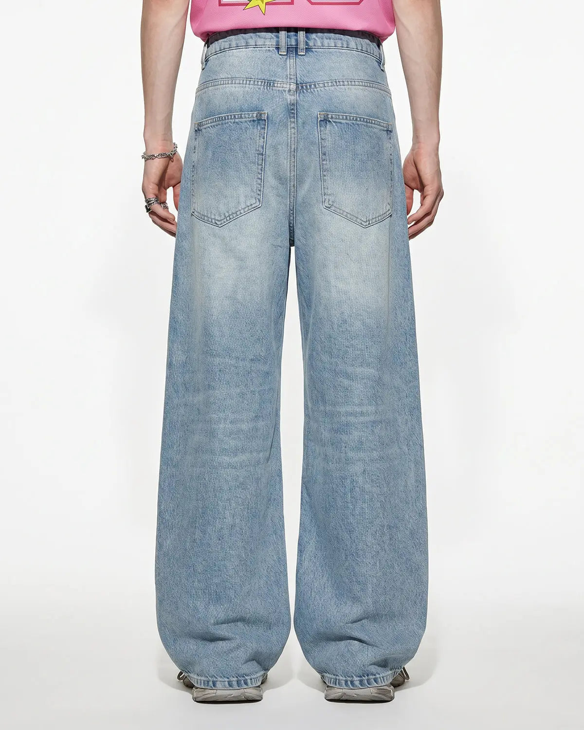 Baggy jeans with asymmetric button details from INFLATION's streetwear collection, featuring a relaxed fit and casual style.