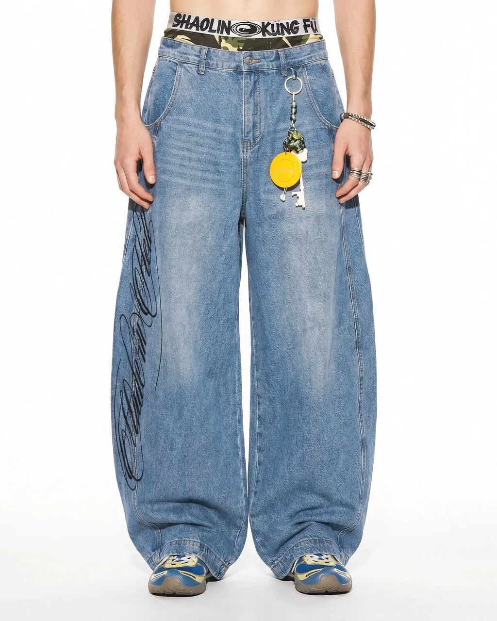 Inflation Script Graphic Barrel Jeans showing baggy fit and bold script logo on navy blue denim pants.