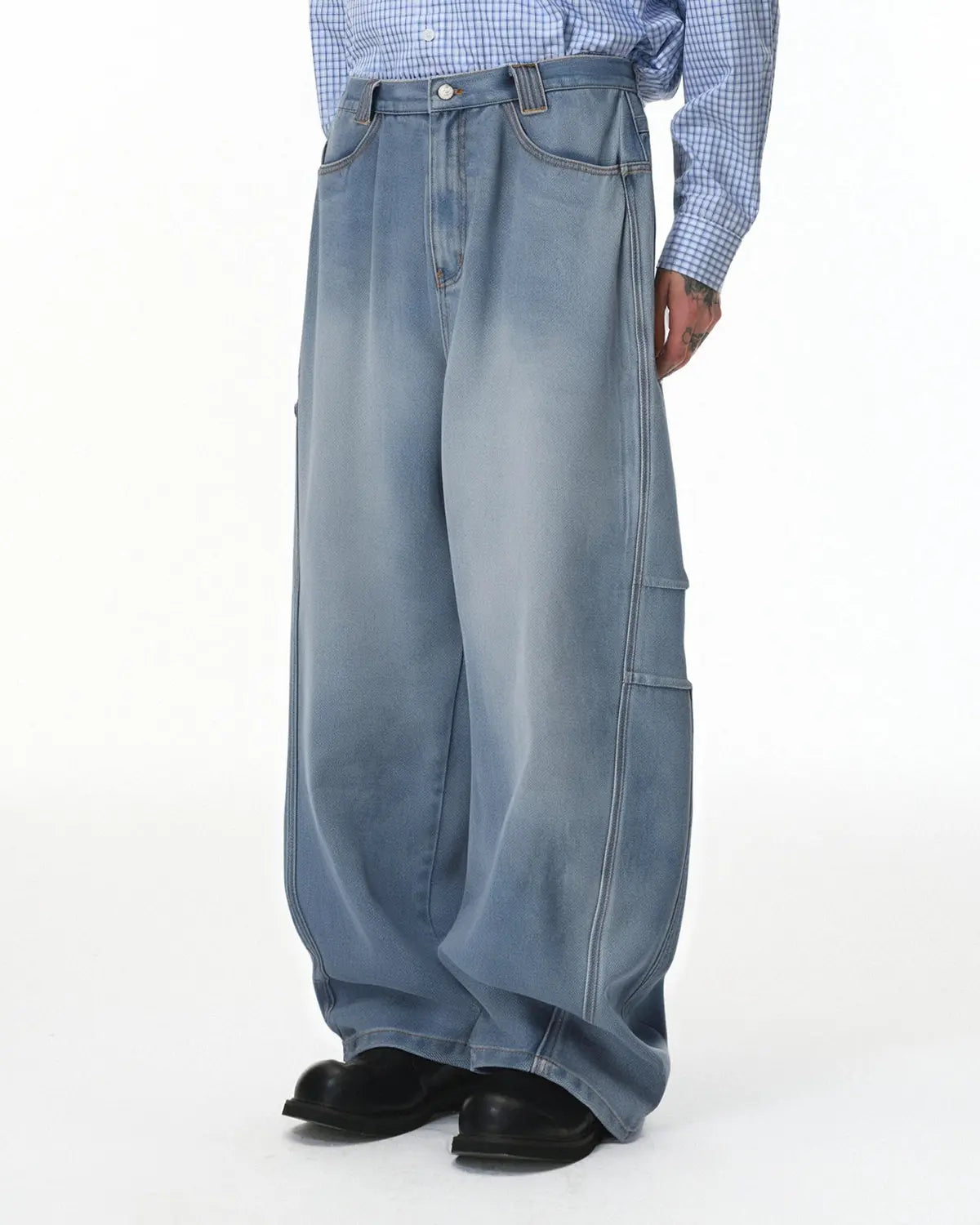Distressed baggy cargo jeans by Flation, featuring a relaxed fit with ripped detailing and multiple cargo pockets.