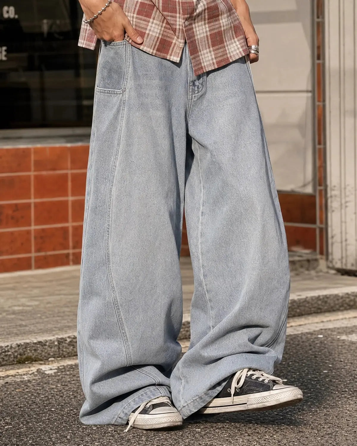 Flation acid washed distressed barrel jeans with a relaxed fit, showing the washed denim texture and distressed details.