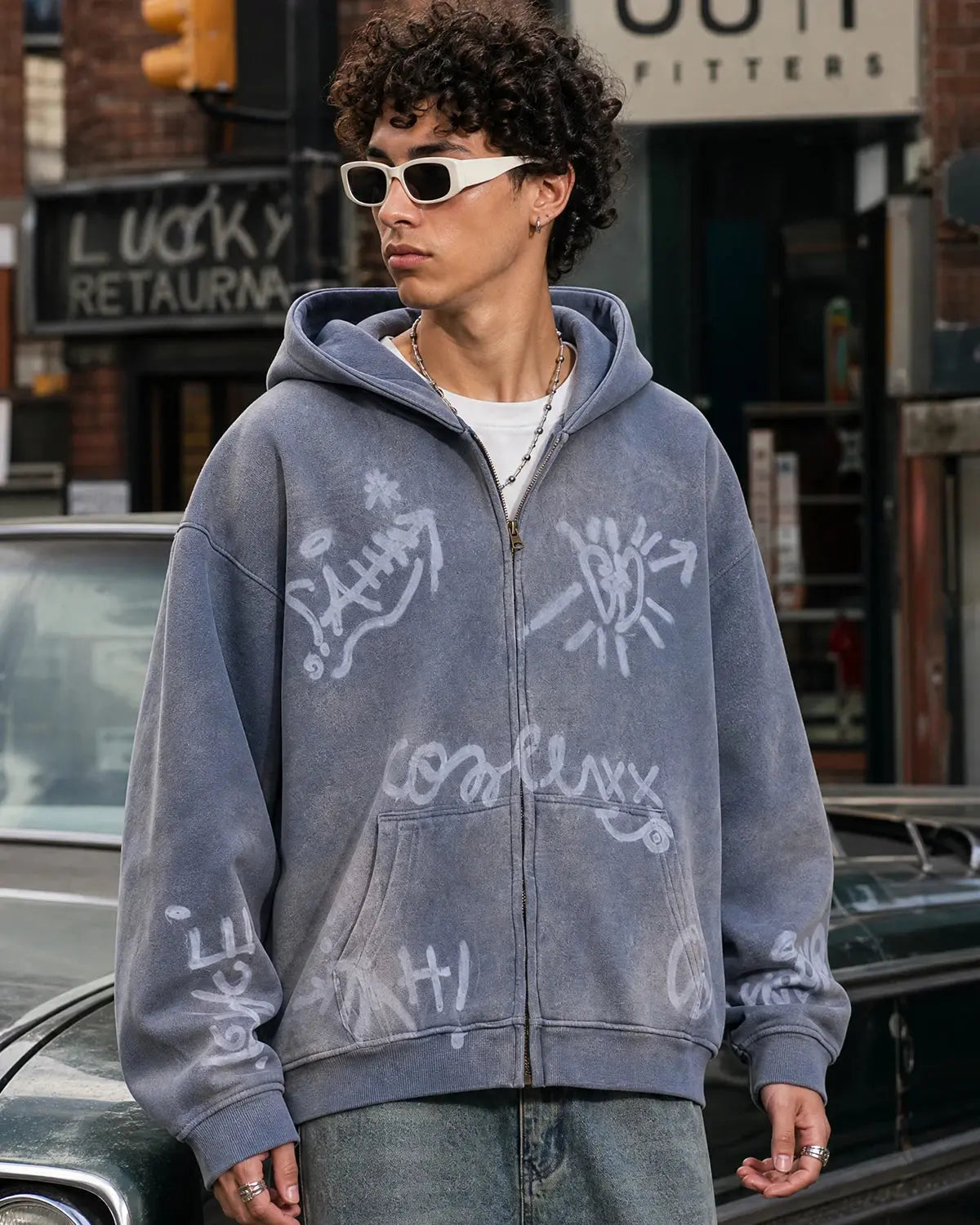 Flation graffiti washed zip-up hoodie featuring a colorful graffiti design and a casual, relaxed fit on a model.