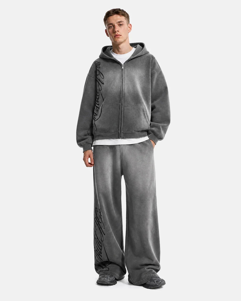 Acid washed Flation Streetwear sweatpants with relaxed fit and distressed fabric, casual style, shown on a model.