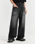 Black washed baggy jeans by Flation Streetwear, relaxed fit with distressed details and casual street style appearance.