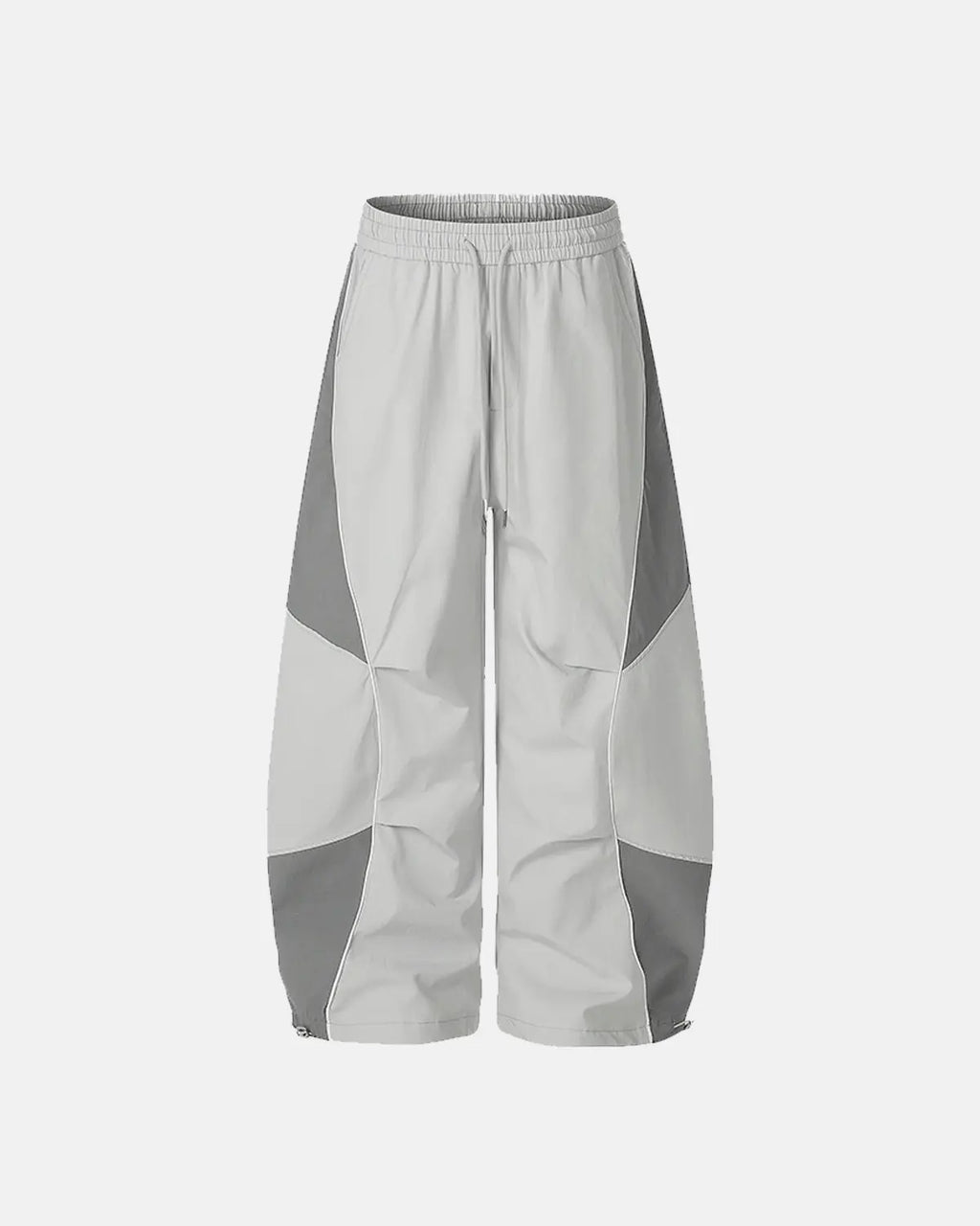Inflation Streetwear contrast panel baggy track pants with black and white color blocks and relaxed fit, casual athletic style.