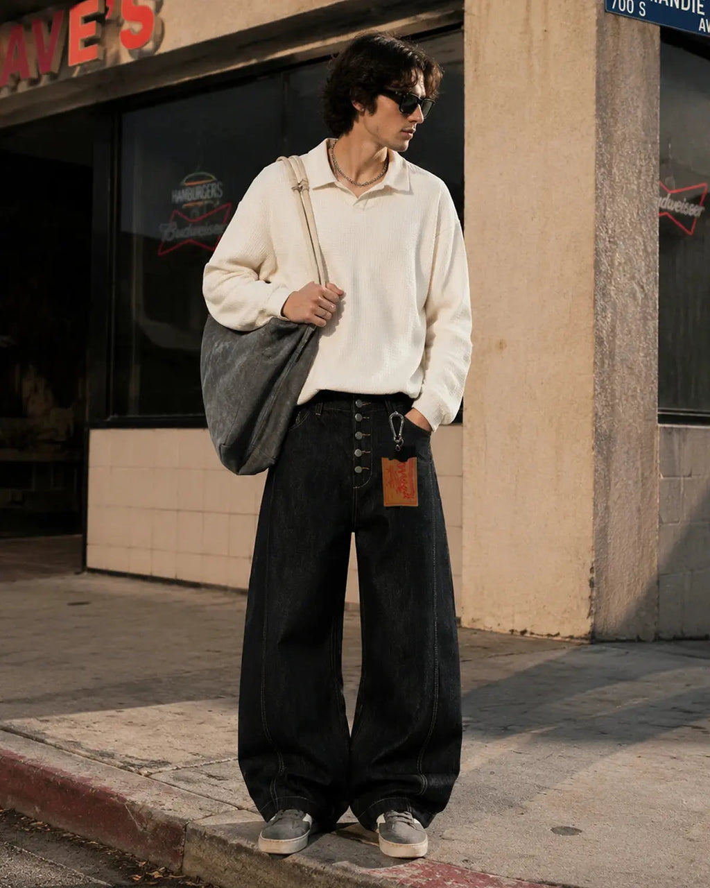 Black buttons-up barrel baggy jeans from INFLATION Streetwear, featuring relaxed fit and casual style with prominent button details.