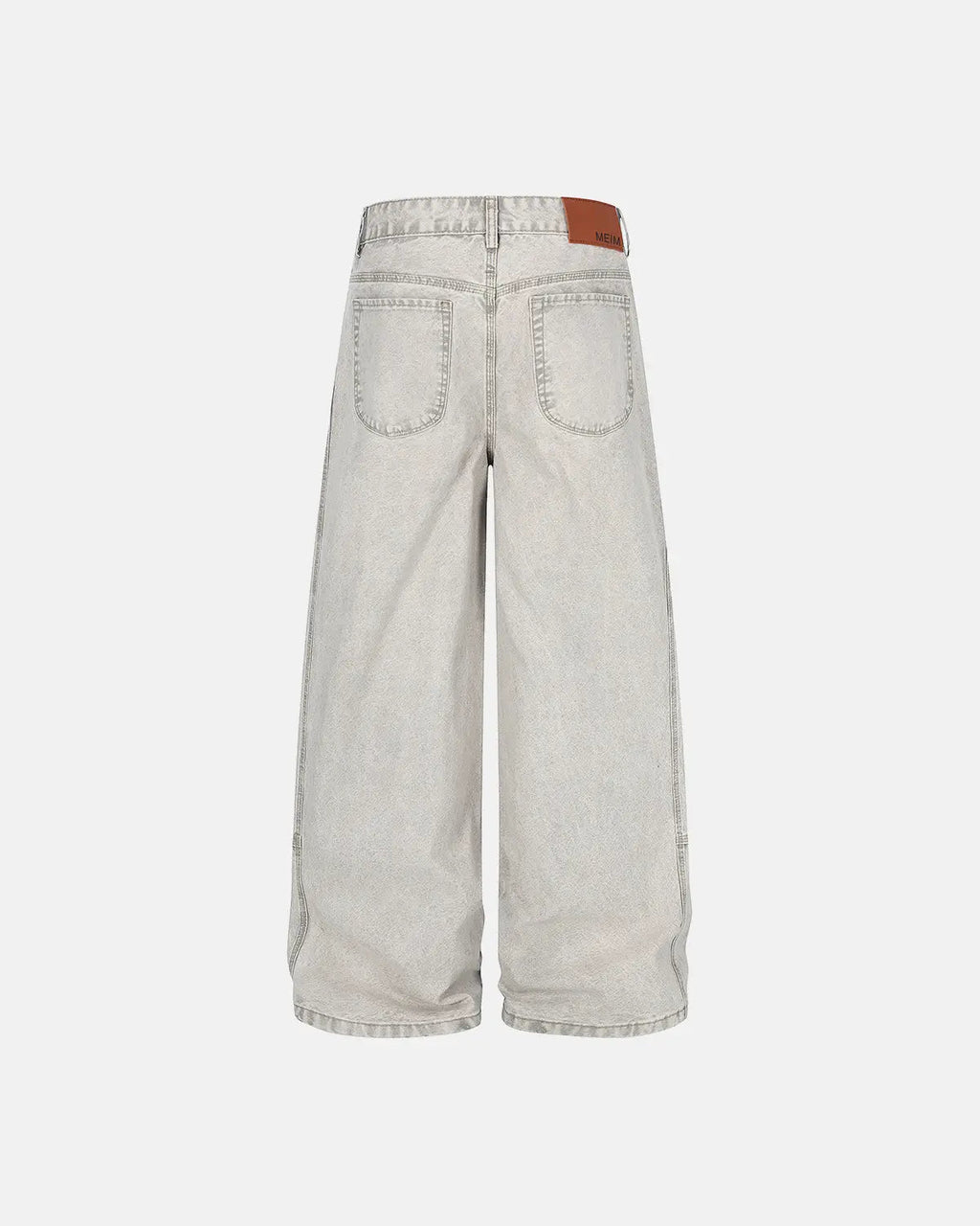 Deconstructed distressed barrel jeans by INFLATION with ripped details and a relaxed fit, styled with a casual urban look.