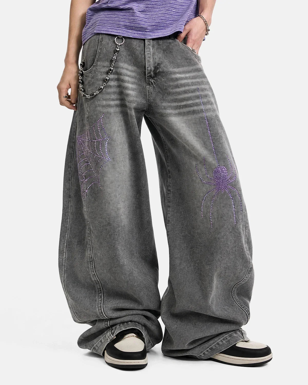 Flation streetwear spider graphic rhinestone barrel jeans featuring a bold spider design on dark denim pants.