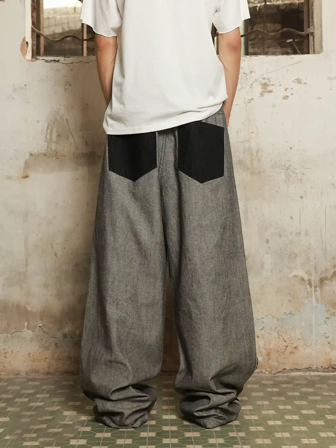 Distressed reverse design baggy jeans by INFLATION featuring a relaxed fit and ripped details for streetwear style.