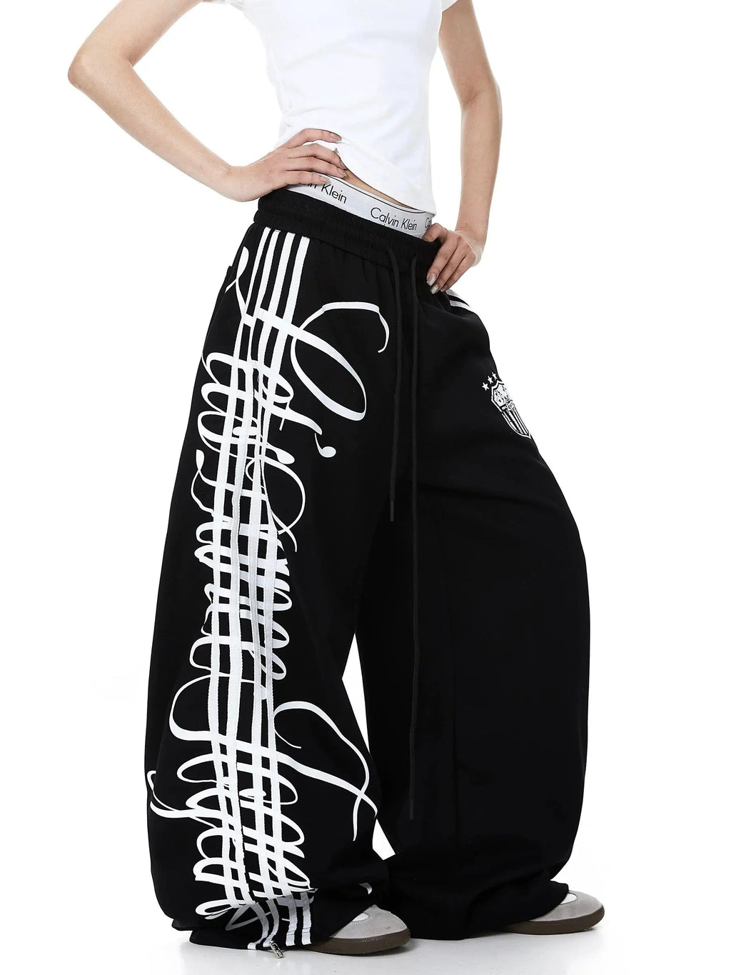 Inflation Script Stripe Baggy Sweatpants, relaxed fit with bold stripe design, casual streetwear style, soft fabric, comfortable fit.