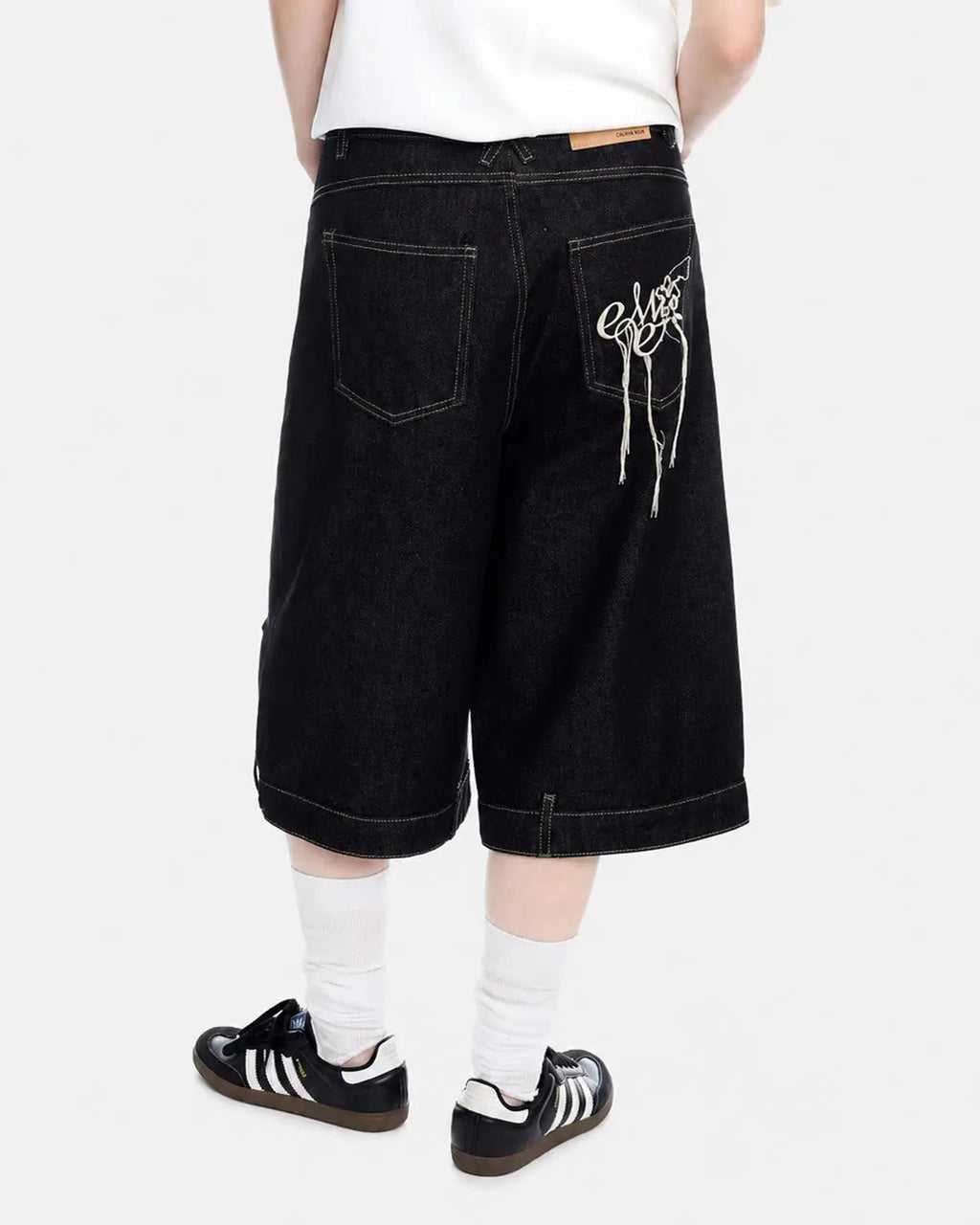 Deconstructed raw denim jorts by INFLATION, casual streetwear pants with distressed detailing and frayed hems.