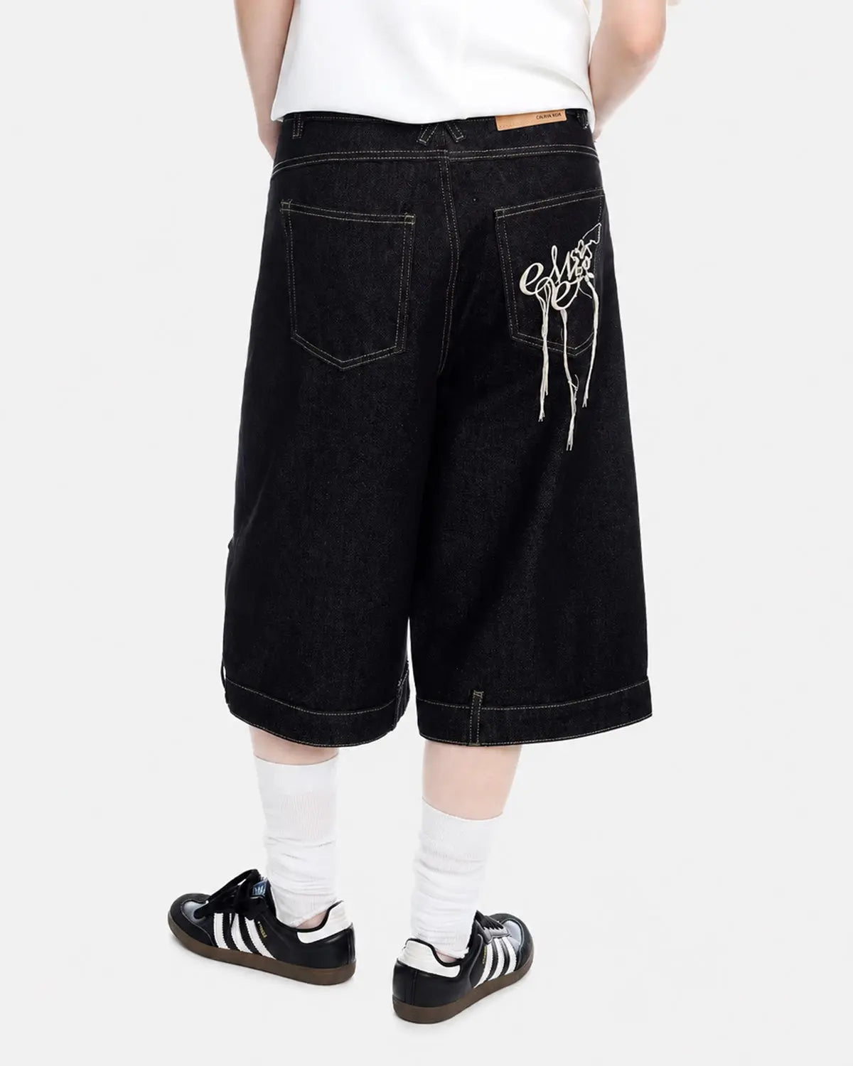 Deconstructed raw denim jorts by INFLATION, casual streetwear pants with distressed detailing and frayed hems.