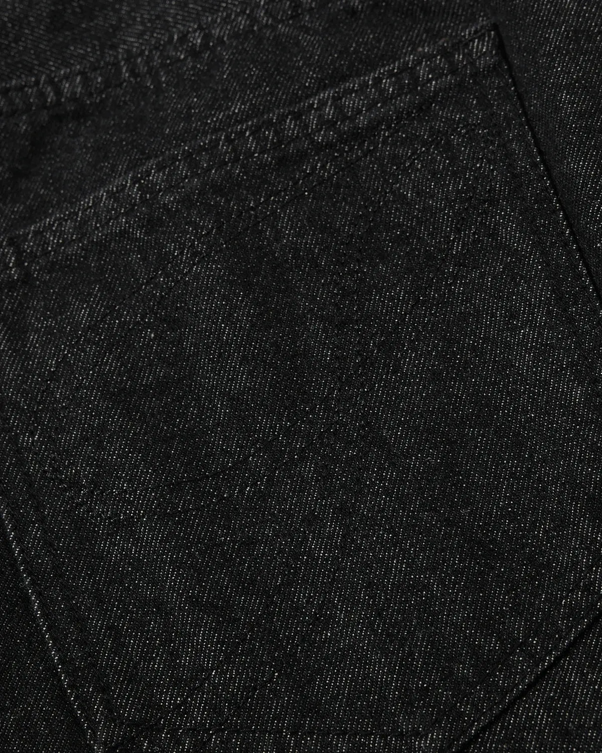 Asymmetric raw denim jorts by INFLATION, stylish streetwear pants with button details and distressed raw denim finish.