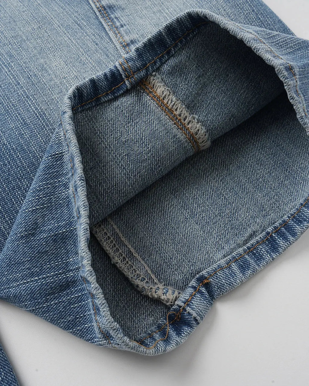 Bamboo weave cinch back baggy jeans by INFLATION featuring a relaxed fit and stylish design, shown in a front view.