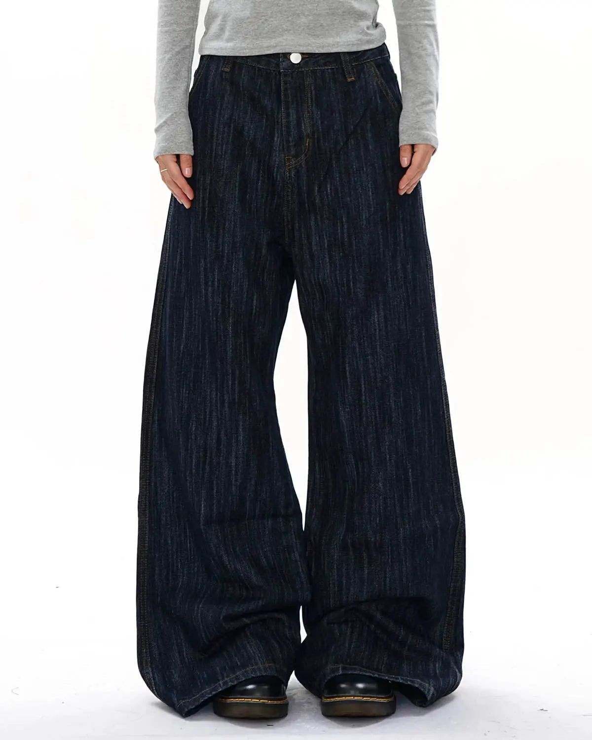 Dark indigo wide bootcut jeans by INFLATION Streetwear, shown hanging with visible belt loops and classic five-pocket design.